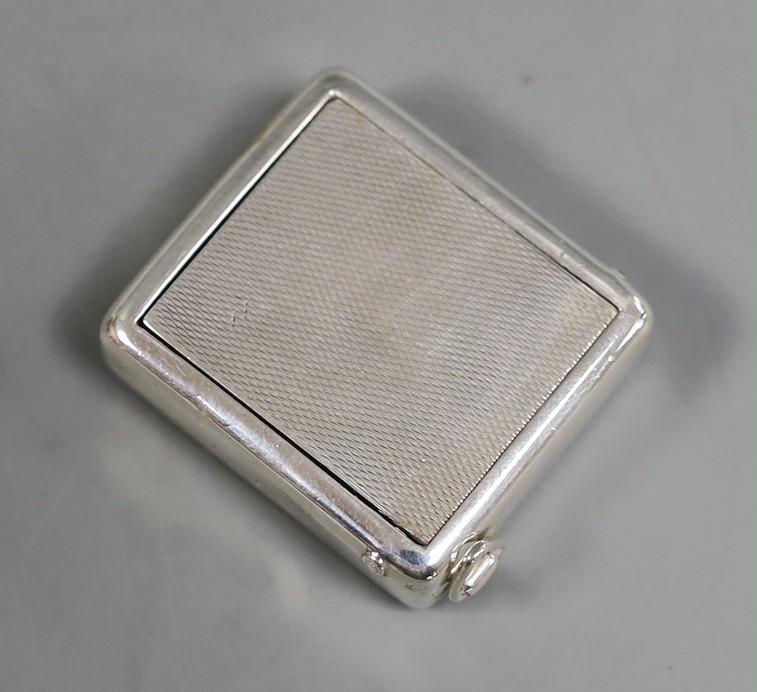 A 1930's engine turned silver traveling watch, retailed by Dunhill, with engraved name, import marks for Hernu, Peron & Stockwell Ltd? London, 1937, 35mm.